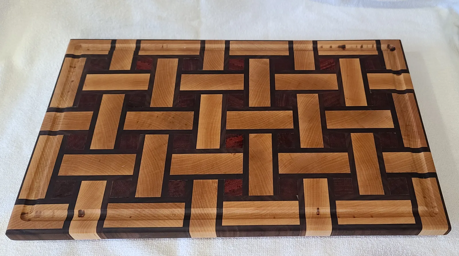 Basket Weave Cutting Board in Hard Maple, Black Walnut, Padauk — handcrafted by Timber and Tides Woodcraft in Northern Colorado